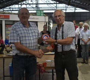 Exeter - Judge Alan West presents Arfon Hughes with Champion pen of shearling ewes